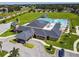 An aerial view of a community pool featuring plenty of seating and lounge chairs with umbrellas at 939 Van Loon Ct, Kissimmee, FL 34758