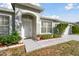 Close up of the front entryway, showcasing the arched doorway and lush landscaping at 939 Van Loon Ct, Kissimmee, FL 34758