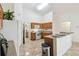 Bright kitchen featuring tile floors, light wood cabinetry, and white appliances at 939 Van Loon Ct, Kissimmee, FL 34758