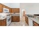 This is a clean kitchen with light wood cabinets, and white appliances, and neutral countertops at 939 Van Loon Ct, Kissimmee, FL 34758