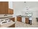 Functional kitchen features light wood cabinets, tile flooring, and open to the living room at 939 Van Loon Ct, Kissimmee, FL 34758