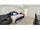 Spacious bedroom with neutral carpeting, ceiling fan, and private bath access at 939 Van Loon Ct, Kissimmee, FL 34758