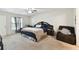 This is a spacious bedroom with a large bed, ceiling fan, and natural light at 939 Van Loon Ct, Kissimmee, FL 34758