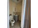 This is a bathroom with a toilet, sink, vanity, medicine cabinet, and a tiled shower area at 2600 Elm Ave, Sanford, FL 32773