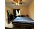 This is a cozy bedroom with a ceiling fan and a blue striped bed at 2600 Elm Ave, Sanford, FL 32773