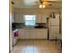 Bright kitchen featuring tiled floor, white cabinets, and updated appliances with window lighting at 2600 Elm Ave, Sanford, FL 32773