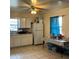 A clean kitchen with neutral-toned tiled flooring, white cabinetry, and a window for natural light at 2600 Elm Ave, Sanford, FL 32773