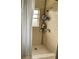 This is a tiled shower area with a shower head, window, curtain, and storage shelves at 2600 Elm Ave, Sanford, FL 32773