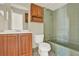 Bathroom featuring a sink with a wood cabinet, toilet and tub at 10 Trophy Ln, Kissimmee, FL 34759