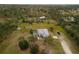 Aerial shot of a property with a home, expansive land, and surrounding trees at 1045 S State Road 415, New Smyrna Beach, FL 32168