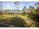 Expansive backyard featuring a covered shelter, perfect for outdoor activities and storage at 1045 S State Road 415, New Smyrna Beach, FL 32168