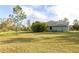 Large lot with lush green grass, beautiful landscaping, and a partially visible home exterior at 1045 S State Road 415, New Smyrna Beach, FL 32168