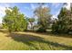 Lush green backyard showcasing mature trees and landscaping at 1045 S State Road 415, New Smyrna Beach, FL 32168