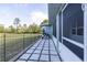 Backyard patio area with screened porch, a grill, and fenced yard at 1045 S State Road 415, New Smyrna Beach, FL 32168
