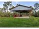 Open barn with ample space for tractors and equipment in a lush green landscape at 1045 S State Road 415, New Smyrna Beach, FL 32168
