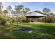 View of a well-maintained open barn with tractors and equipment, ideal for storage or agricultural use at 1045 S State Road 415, New Smyrna Beach, FL 32168