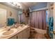 Bathroom featuring double sinks, a shower and tub combination, and updated fixtures at 1045 S State Road 415, New Smyrna Beach, FL 32168
