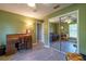 Bedroom featuring green walls, a sliding mirror door closet and wood-look tile flooring at 1045 S State Road 415, New Smyrna Beach, FL 32168