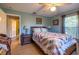 Cozy bedroom features wood flooring, ceiling fan and decor at 1045 S State Road 415, New Smyrna Beach, FL 32168