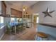 Bright dining area with natural light, a ceiling fan, and access to the kitchen at 1045 S State Road 415, New Smyrna Beach, FL 32168