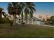 Inviting home exterior with mature palm trees and lush green lawn at 1045 S State Road 415, New Smyrna Beach, FL 32168