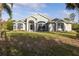 Beautiful home exterior featuring a well-maintained lawn and manicured landscaping at 1045 S State Road 415, New Smyrna Beach, FL 32168