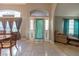 Bright foyer showcases tile flooring, natural light, decorative front door and easy access to living room at 1045 S State Road 415, New Smyrna Beach, FL 32168