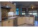Modern kitchen boasts stainless steel appliances, wood cabinets, and a convenient breakfast bar at 1045 S State Road 415, New Smyrna Beach, FL 32168
