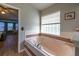Bright main bathroom featuring a soaking tub with tile surround and a window that provides natural light at 1045 S State Road 415, New Smyrna Beach, FL 32168