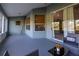 Screened patio featuring comfortable seating, stylish decor, and outdoor access at 1045 S State Road 415, New Smyrna Beach, FL 32168