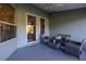 Comfortable outdoor patio with wicker furniture, ceiling fan, and sliding glass doors at 1045 S State Road 415, New Smyrna Beach, FL 32168