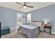 Comfortable bedroom featuring carpeted floors, a ceiling fan, and a serene, light blue paint scheme at 12144 Philosophy Way, Orlando, FL 32832