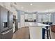 Bright kitchen featuring white cabinets, modern appliances, and an island with bar seating at 12144 Philosophy Way, Orlando, FL 32832