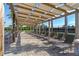 Relaxing poolside lounge area with comfortable lounge chairs underneath a pergola, perfect for soaking up the sun at 12144 Philosophy Way, Orlando, FL 32832