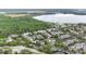 Aerial view of community with tennis court, pool, and lake nearby at 13013 Mulberry Park Dr # 222, Orlando, FL 32821