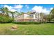 Exterior view of building with well-manicured lawn and bench at 13013 Mulberry Park Dr # 222, Orlando, FL 32821