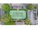 Aerial shot of community tennis court surrounded by mature landscaping and parking at 13013 Mulberry Park Dr # 222, Orlando, FL 32821