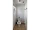 Small half-bathroom with tile floors, a toilet, and a small window at 14218 Squirrel Run, Orlando, FL 32828