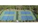 Aerial view of two pristine tennis courts within a vibrant community at 14218 Squirrel Run, Orlando, FL 32828
