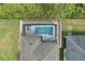Drone shot over screened pool with outdoor seating, white fence, lush lawn, roof, and neighboring house at 14384 Alafaya Oak Bnd, Orlando, FL 32828
