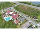Aerial view of the community clubhouse with pool, parking, playground, and landscaped street at 14384 Alafaya Oak Bnd, Orlando, FL 32828