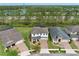 Overhead shot of a community with a water feature and lush greenery. The home has a brick driveway and is well-landscaped at 14384 Alafaya Oak Bnd, Orlando, FL 32828