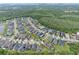 Aerial view of homes in a suburban neighborhood surrounded by trees with highway access at 14384 Alafaya Oak Bnd, Orlando, FL 32828