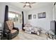 Cozy bedroom features a fan, accent chair, and a bright window at 14384 Alafaya Oak Bnd, Orlando, FL 32828