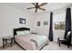 Carpeted bedroom with gray blackout curtains, decorative lighting, and ceiling fan at 14384 Alafaya Oak Bnd, Orlando, FL 32828