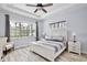 Bright bedroom with tray ceiling, large window with views, and white furniture at 14384 Alafaya Oak Bnd, Orlando, FL 32828