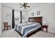 Cozy bedroom featuring carpeted floors, a ceiling fan, and a window with natural light at 14384 Alafaya Oak Bnd, Orlando, FL 32828