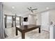 Upstairs bonus room features recessed lighting, windows, and a large billiards table at 14384 Alafaya Oak Bnd, Orlando, FL 32828