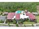Community clubhouse with a pool, palm trees, manicured landscaping, parking, and multiple covered seating areas at 14384 Alafaya Oak Bnd, Orlando, FL 32828