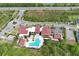 Aerial view of community clubhouse with a pool and splash pad, landscaping, parking, and highway access at 14384 Alafaya Oak Bnd, Orlando, FL 32828